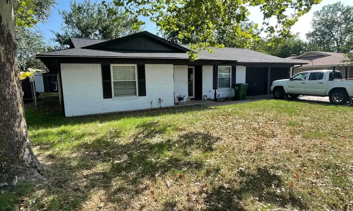 Professional roofing crew working on a residential roof in Southold